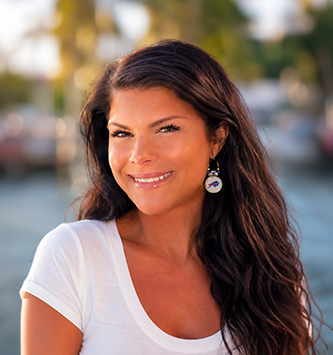Woman wearing Red Buffalo Bling charm hoop earrings